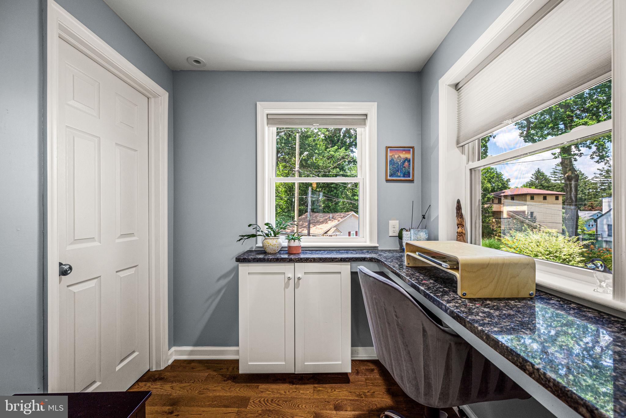 177 Bortondale Road Media, PA 19063 - Photo 18 of 33 a kitchen with granite countertop a stove a sink and wooden cabinets