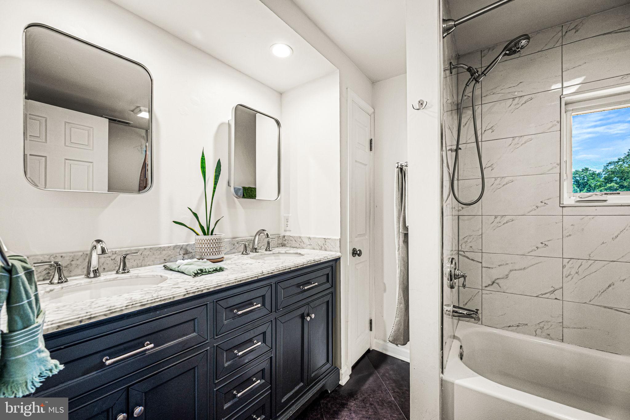 177 Bortondale Road Media, PA 19063 - Photo 23 of 33 a bathroom with a granite countertop sink mirror and a bathtub