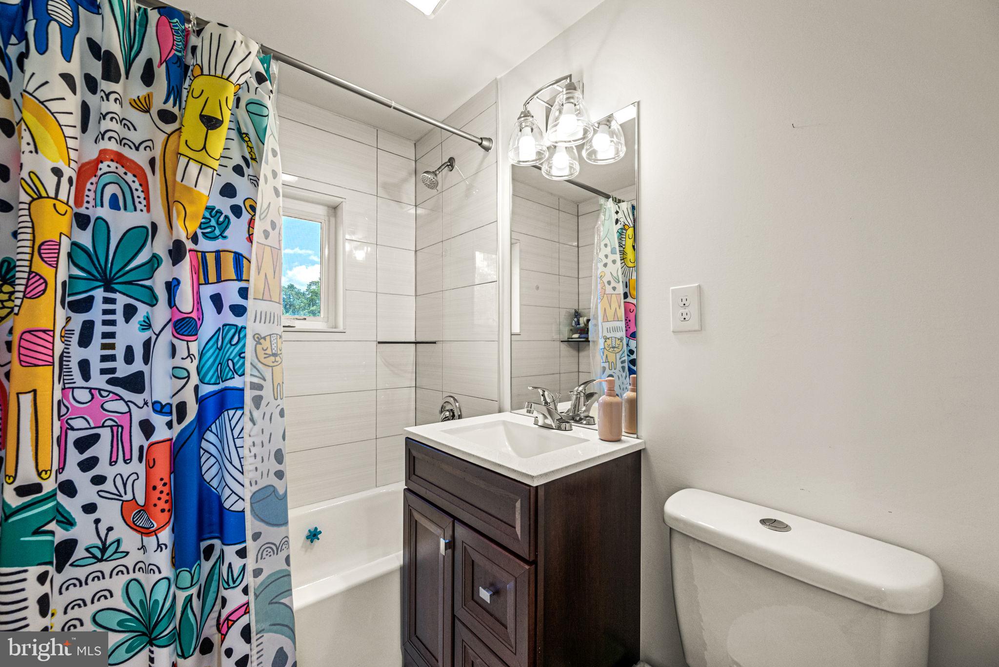 177 Bortondale Road Media, PA 19063 - Photo 28 of 33 a bathroom with a sink a toilet and shower curtain