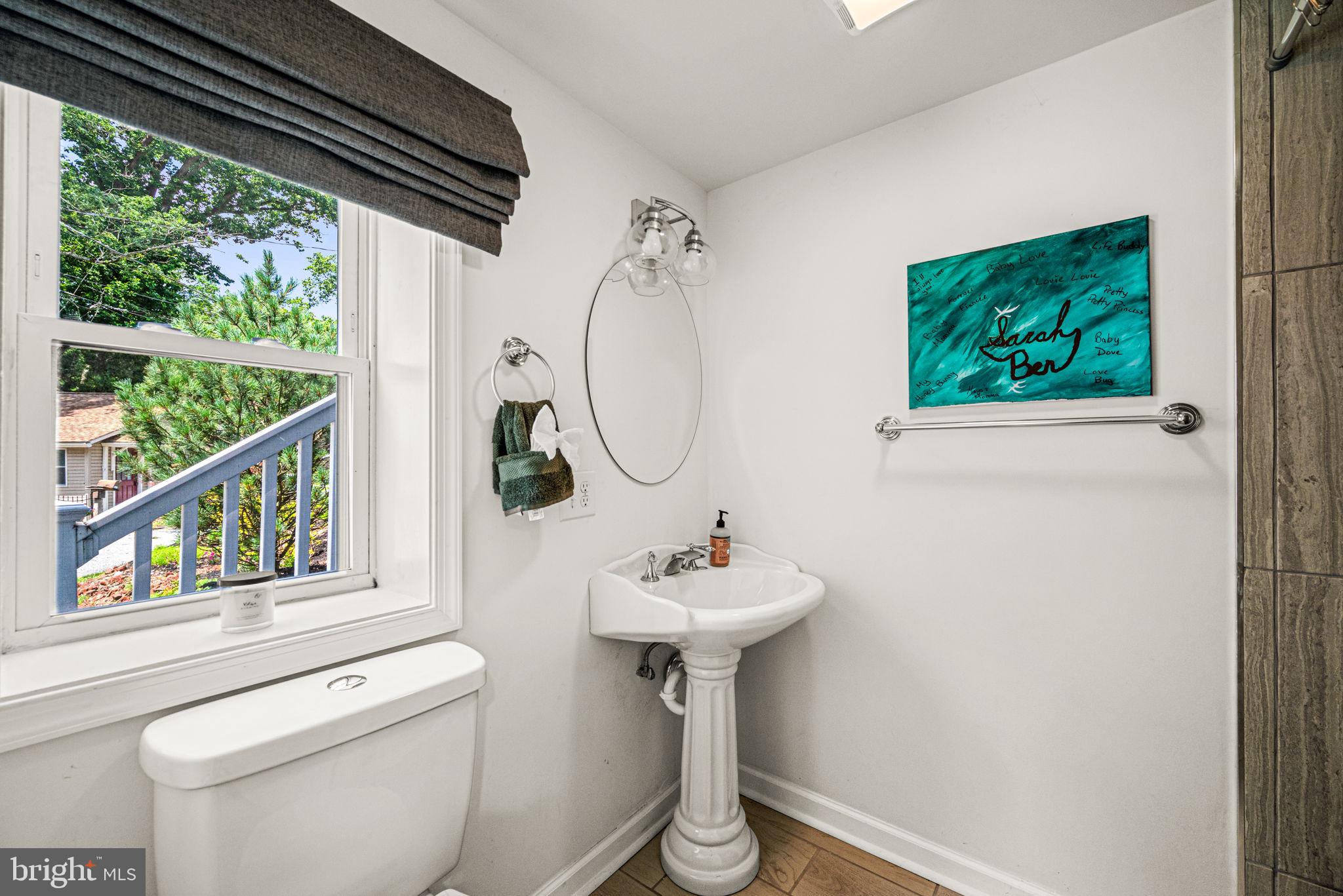177 Bortondale Road Media, PA 19063 - Photo 6 of 33 a bathroom with a sink a mirror and a toilet