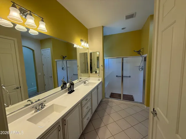 a spacious bathroom with a double vanity sink mirror and double