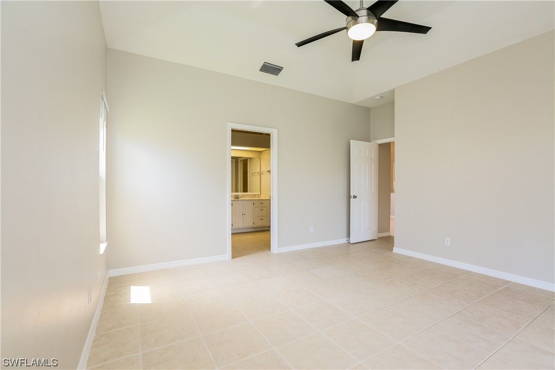 8373 Butternut Road Fort Myers, FL 33967 - Photo 11 of 13 a view of an empty room and chandelier fan