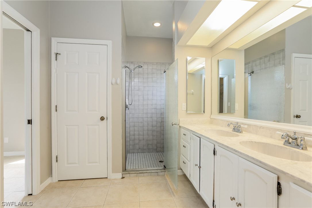 8373 Butternut Road Fort Myers, FL 33967 - Photo 12 of 13 a bathroom with a shower sink and mirror