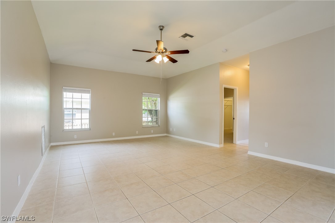8373 Butternut Road Fort Myers, FL 33967 - Photo 8 of 13 an empty room with windows and fan