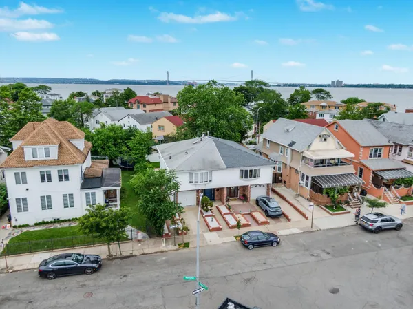 an aerial view of a house with garden space and street view