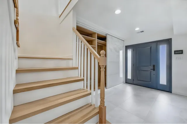 a view of entryway with wooden floor and stairs