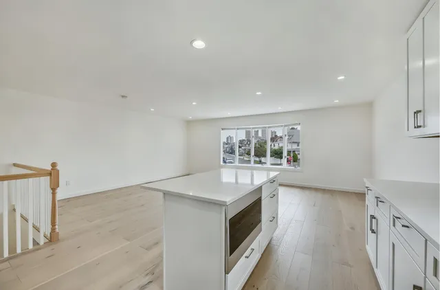 a kitchen with a sink stove and microwave