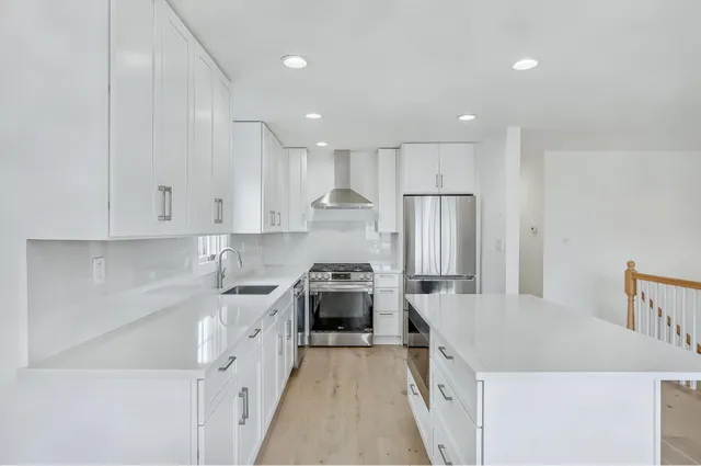 a kitchen with a stove sink and refrigerator