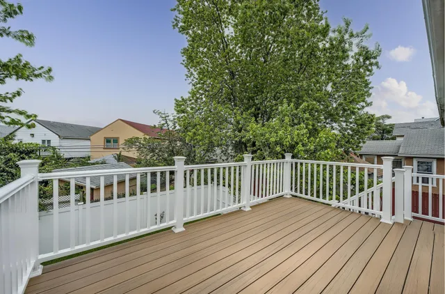 a view of balcony with wooden floor and fence