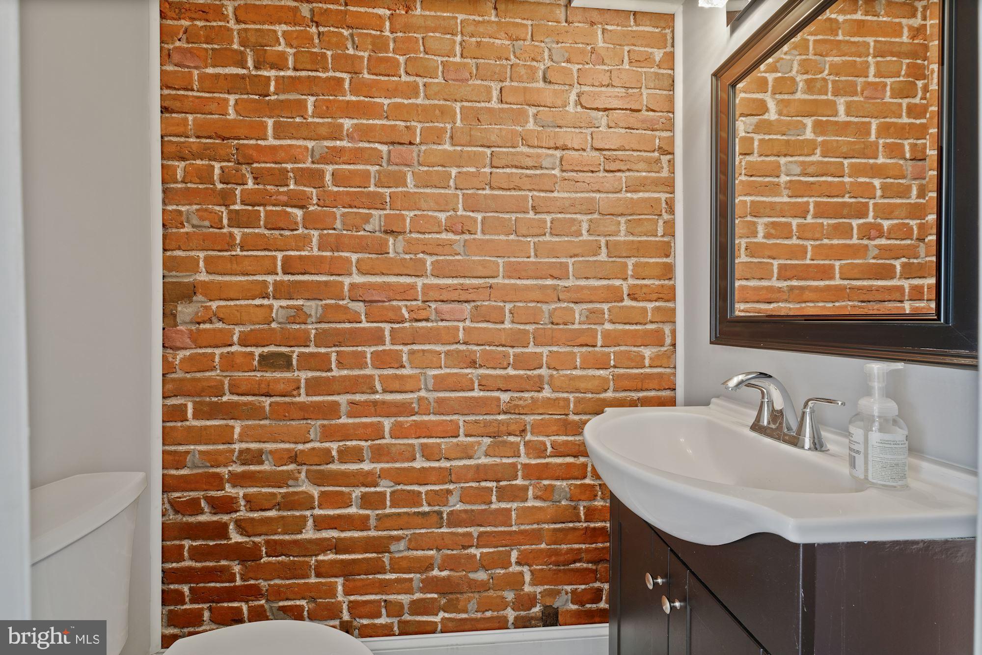 225 Channing Street Northeast Washington, DC 20002 - Photo 10 of 28 Main Level Powder Room with Exposed Brick