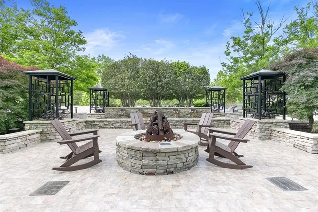 a view of a patio with a table chairs and a small yard