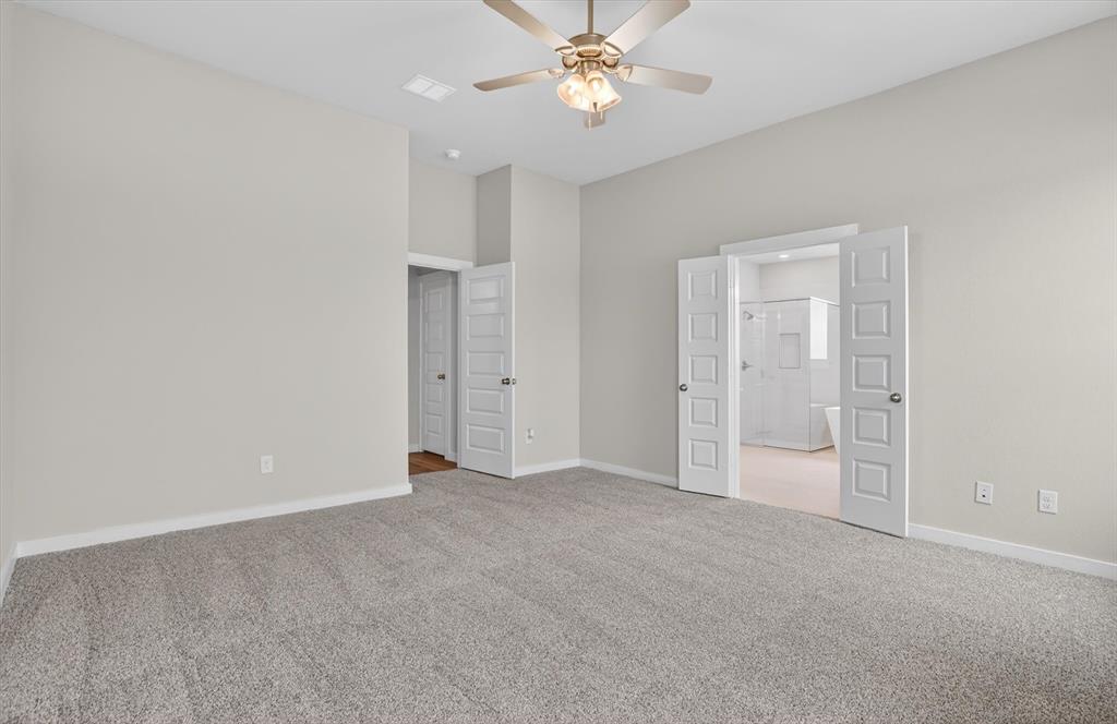 504 Clifton Court Springtown, TX 76082 - Photo 28 of 36 Spacious room featuring vaulted ceilings, light gray wall paint, and gray carpeting