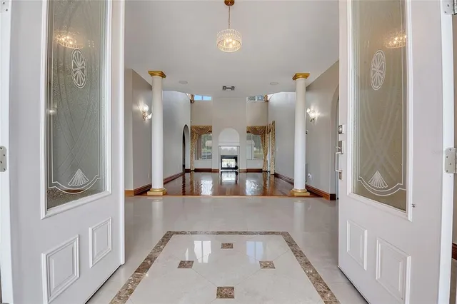 a view of an empty room with glass door and windows