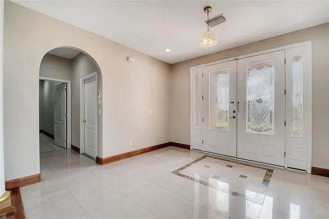 a large kitchen with stainless steel appliances granite countertop a stove a sink dishwasher a refrigerator and a cabinets