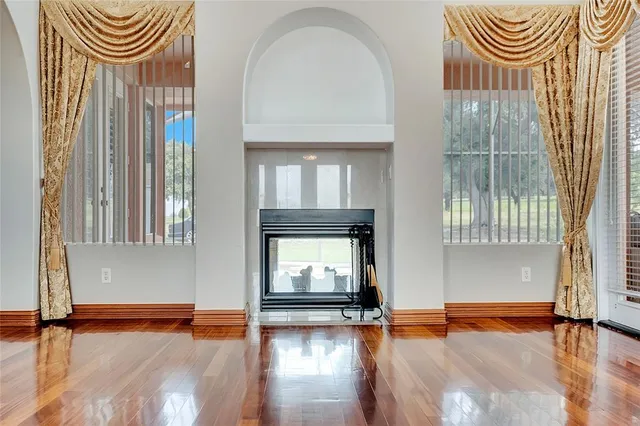 a kitchen with stainless steel appliances granite countertop a sink a stove and a wooden floors