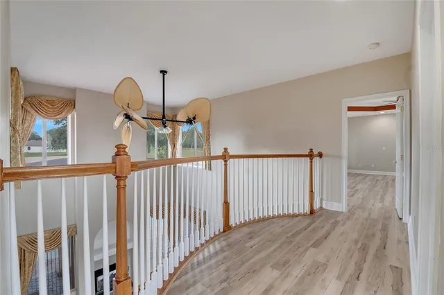 an aerial view of a house with a garden and lake view