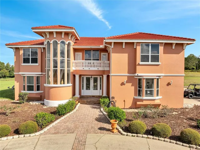 an empty room with wooden floor and stairs