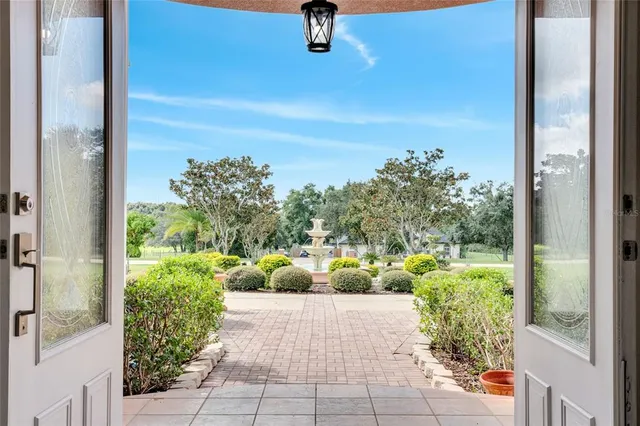 a view of empty room with fireplace and wooden floor