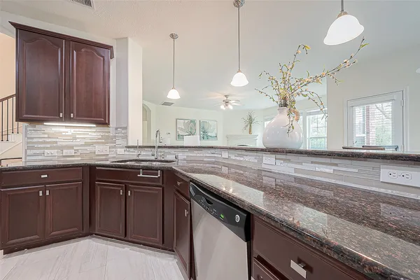 a kitchen with stainless steel appliances granite countertop a refrigerator and a stove