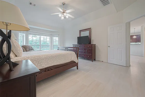 a living room with furniture a flat screen tv and a large window