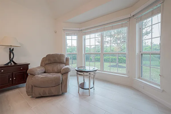 a living room with furniture and a large window
