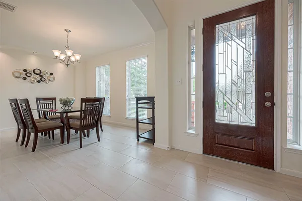 a view of a dining room with furniture and chandelier