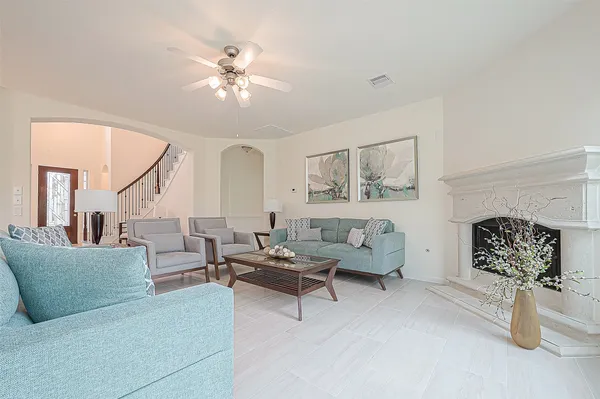 a living room with furniture and a fireplace