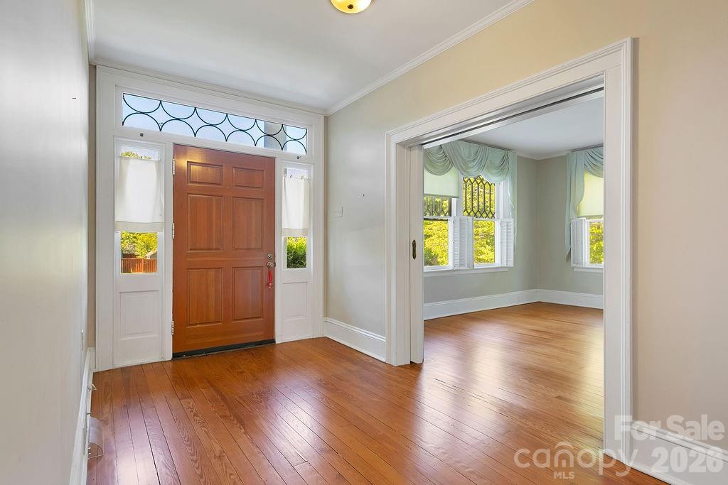208 West Probart Street Brevard, NC 28712 - Photo 8 of 48 wooden floor in an empty room with a window