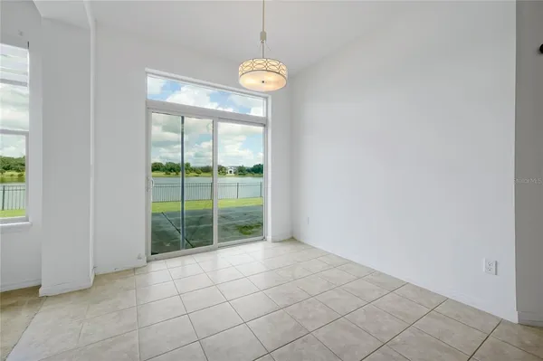 a view of a room with window and front door