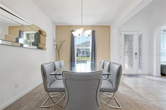 a dining room with furniture and chandelier