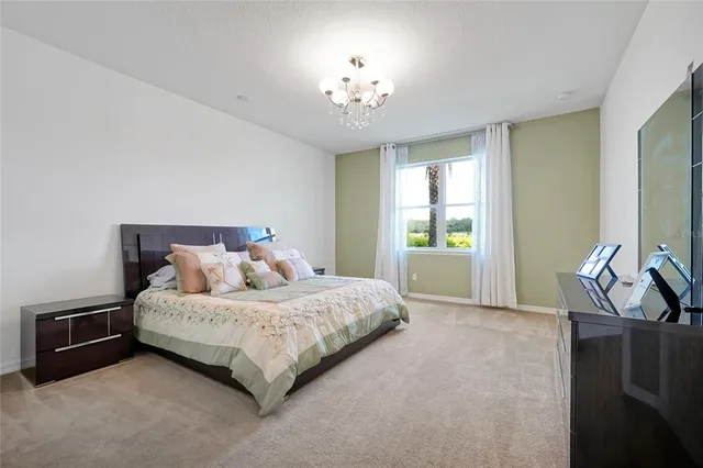 a bedroom with a bed and a lamp