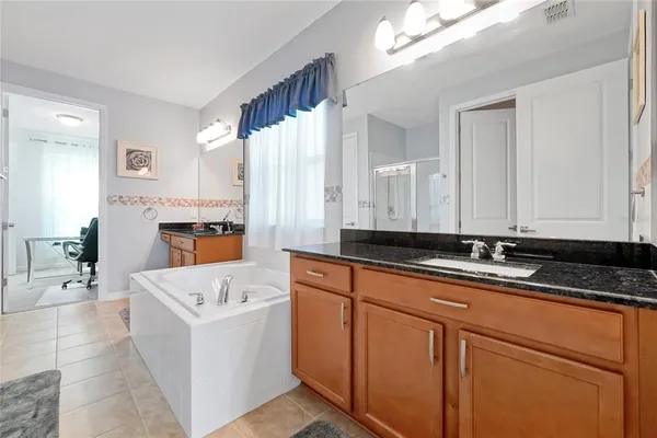 a bathroom with a bathtub and a window