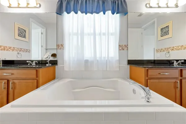 a large white kitchen with a sink and dishwasher a refrigerator with wooden floor