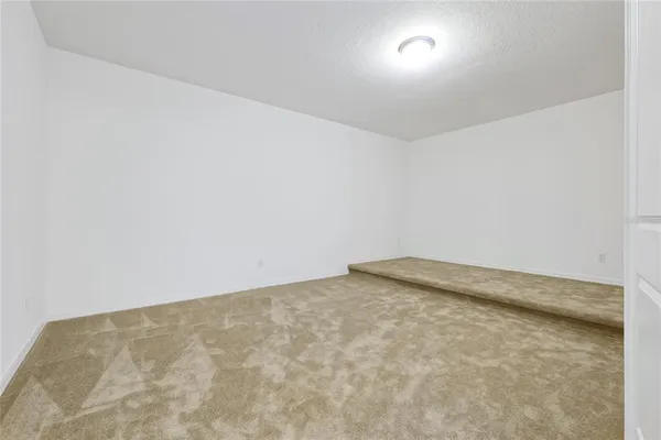 a bedroom with a large bed and a wooden floor