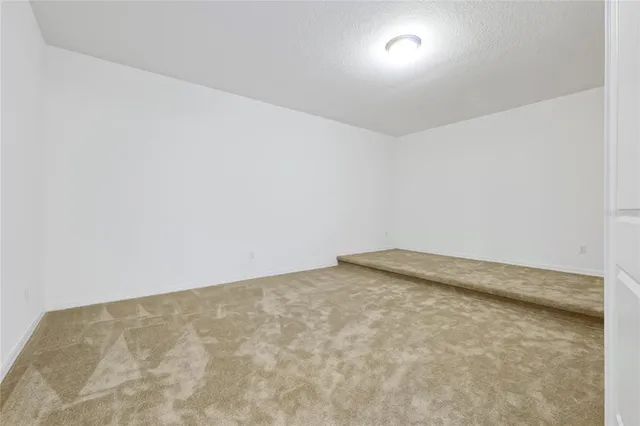 a bedroom with a large bed and a wooden floor