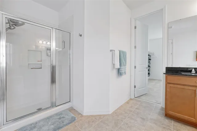 a bedroom with a bed and painting on the wall