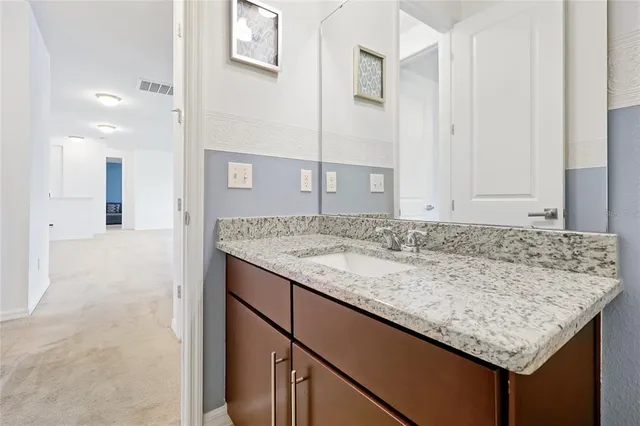 a view of a room with wooden floor and bathroom