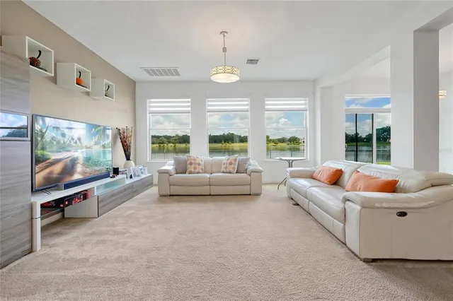 a living room with furniture and a chandelier