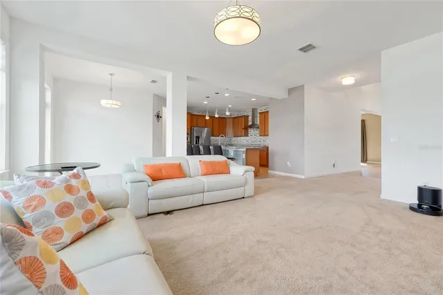 a kitchen with granite countertop a refrigerator and a stove top oven