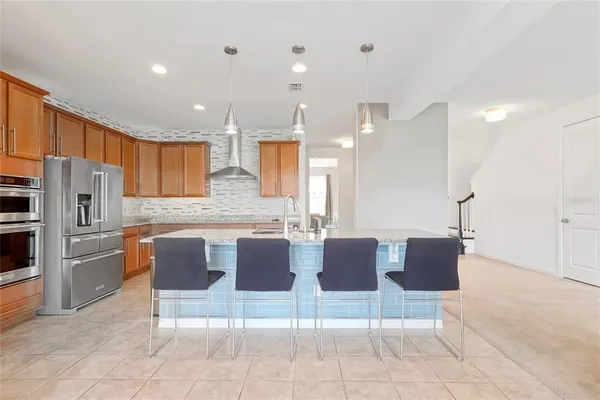 a kitchen with stainless steel appliances granite countertop a sink and cabinets