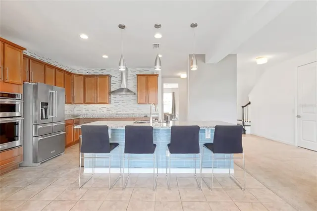 a kitchen with stainless steel appliances granite countertop a sink and cabinets