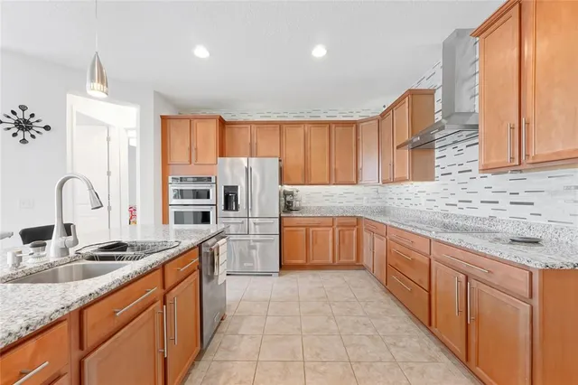 a kitchen with granite countertop white cabinets and stainless steel appliances