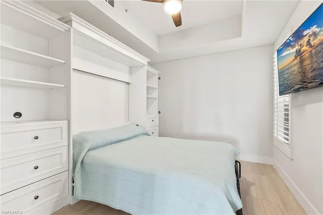 a bedroom with a bed and a mirror