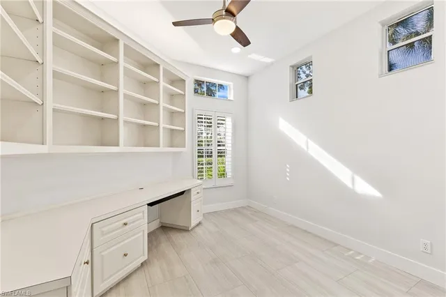 a view of an empty room with a window and closet