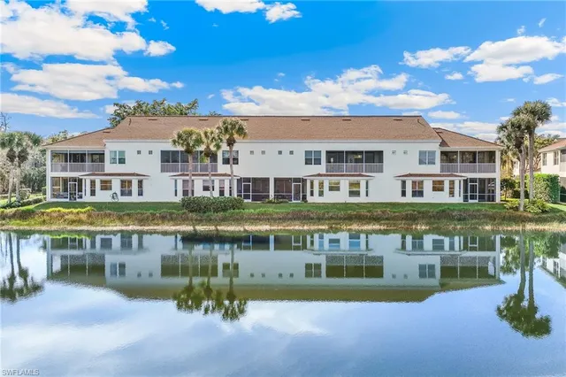 a view of house with a swimming pool and outdoor seating