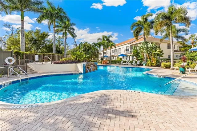 a view of a swimming pool with an outdoor seating