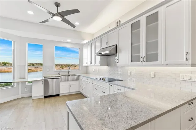a kitchen with a sink stove and cabinets