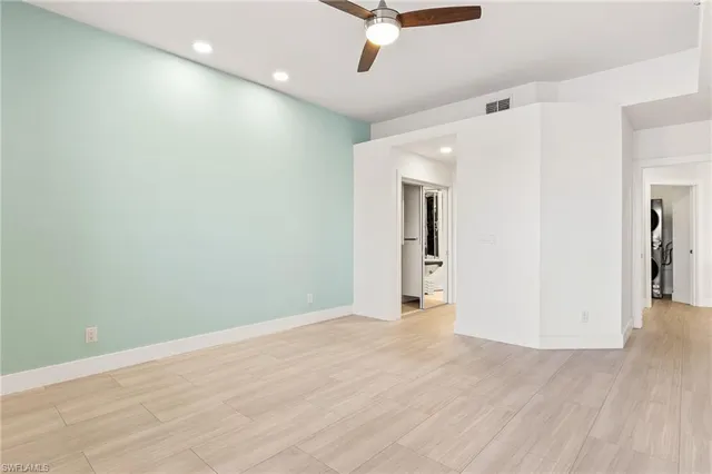 a view of a livingroom with a ceiling fan and wooden floor
