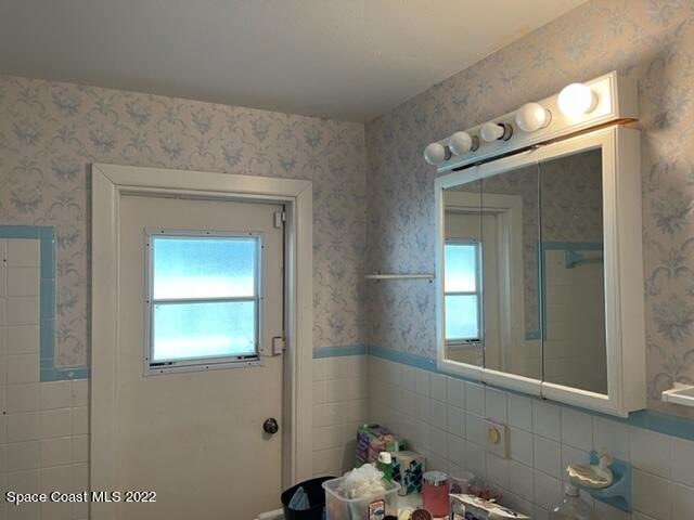 2305 Dairy Road Melbourne, FL 32901 - Photo 13 of 21 a bathroom with a sink and a mirror