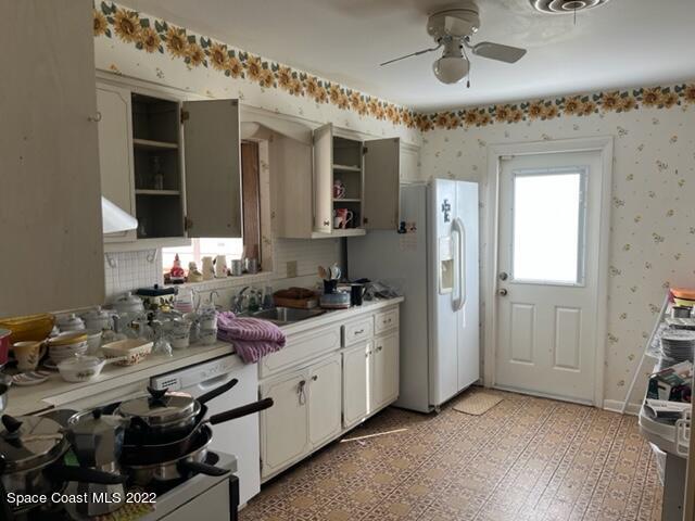 2305 Dairy Road Melbourne, FL 32901 - Photo 3 of 21 a kitchen with a sink stove and cabinets